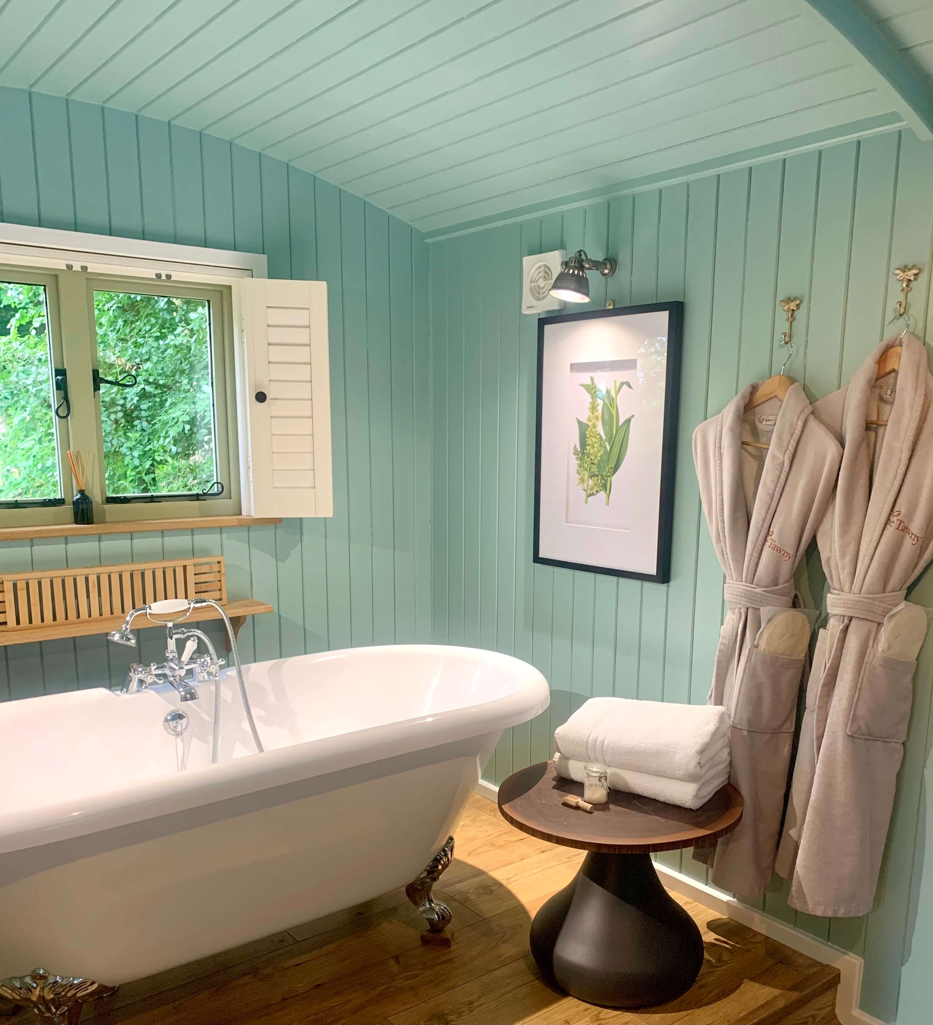 bath tub and bathrobes in the glade hut at the tawny hotel